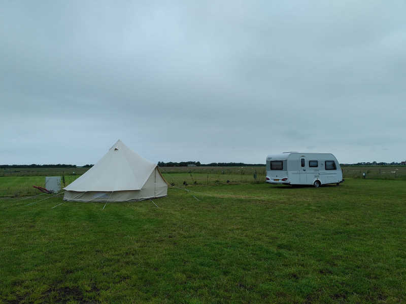 een tent en caravan op camping de Texelaar